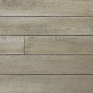 Close-up of Millboard Enhanced Grain composite decking in Limed Oak finish, featuring subtle light grey tones and a realistic wood grain texture that mimics weathered timber for a contemporary outdoor aesthetic