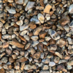 Close-up of 20mm Dorset flint gravel showcasing natural golden and amber tones