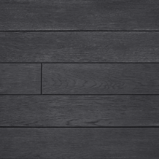 Close-up of Millboard Enhanced Grain decking in Burnt Cedar finish, showcasing a rich, charcoal-black tone with deeply textured wood grain detailing for a striking, contemporary outdoor aesthetic