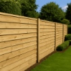 A wooden fence installation in a garden setting, featuring evenly spaced 100mm x 100mm treated fence posts supporting horizontal timber panels. The scene showcases a clean, natural look ideal for residential outdoor spaces